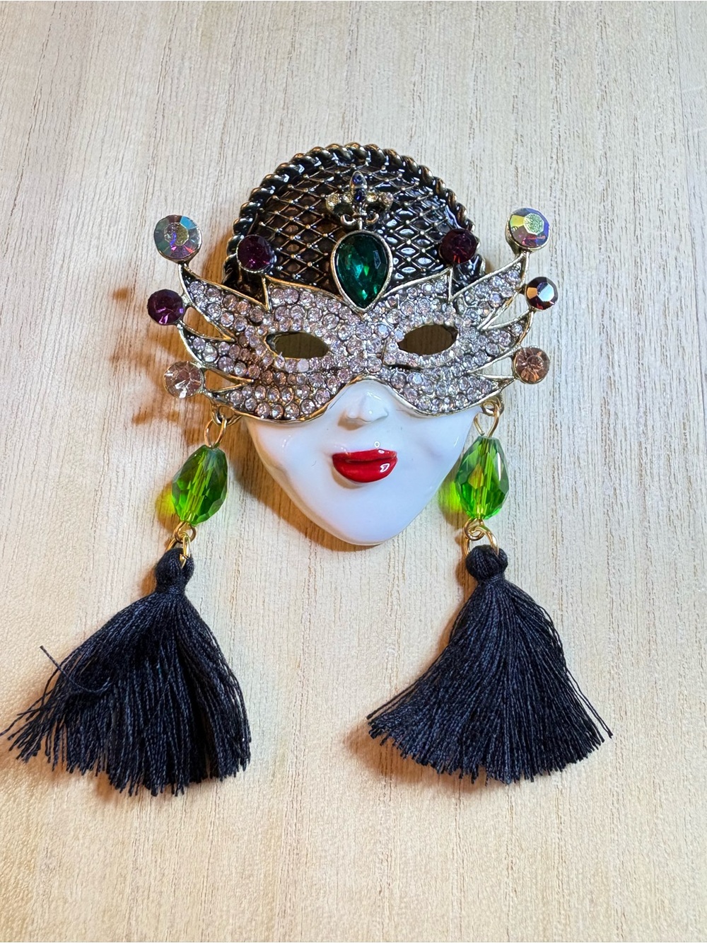 Masquerade Mask Face Brooch with Green Crystal Accents and Black Tassels